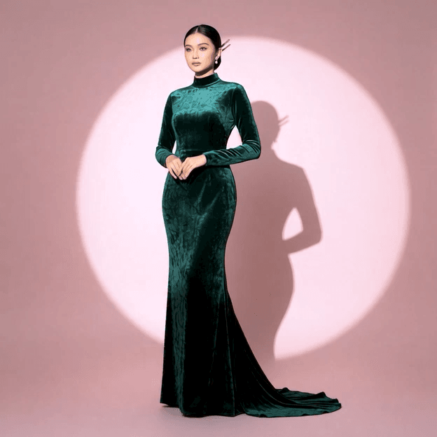 Shot of a young woman wearing a luxurious gown made of deep crushed emerald green velvet